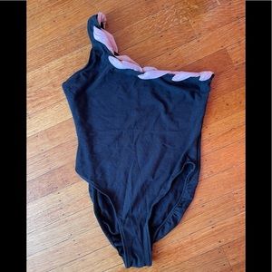Black one shoulder body suit.
